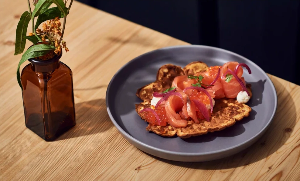 Salmon on waffles with salmon caviar