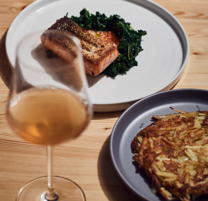 Plate with salmon slice, pickled vegetables, and foam